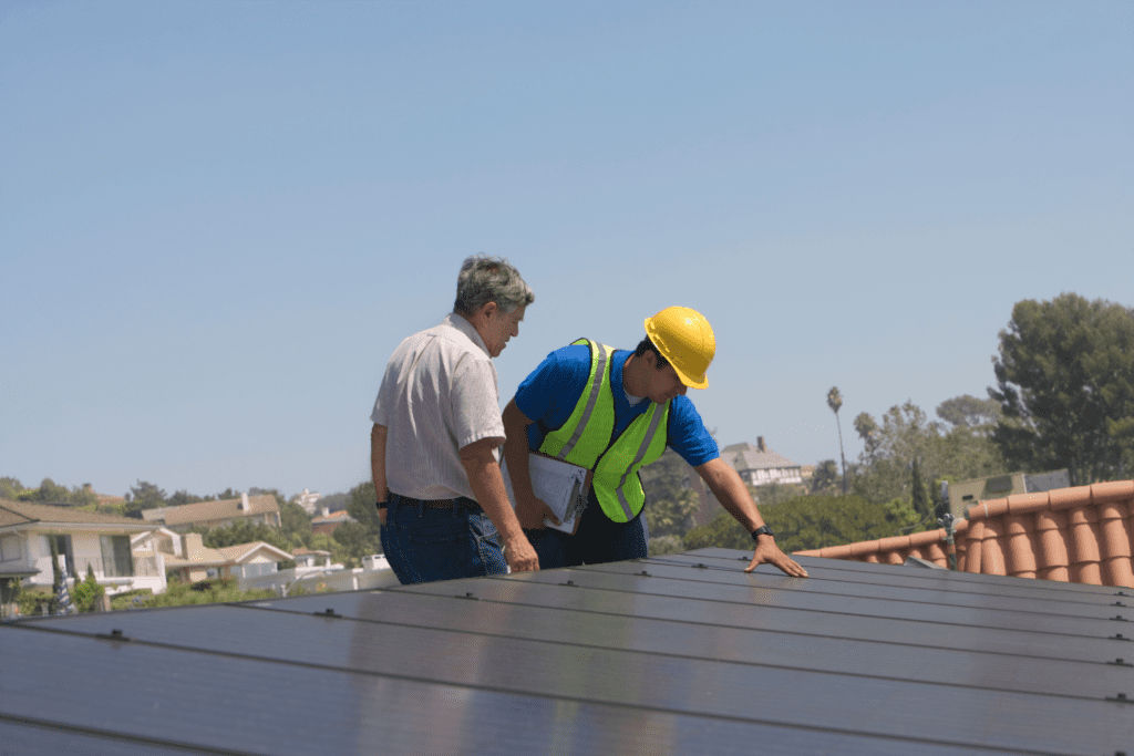 Two men working on a solar panel.